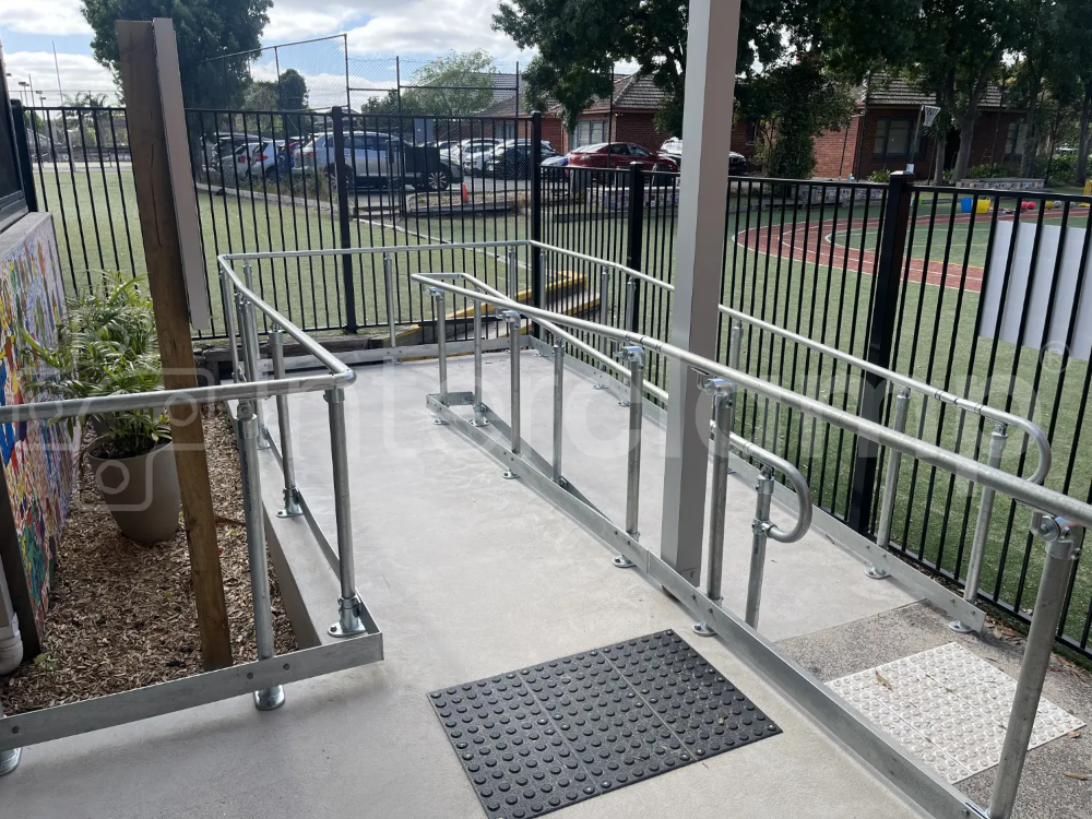 Key clamp disability compliant handrail with toeboard installed at a school